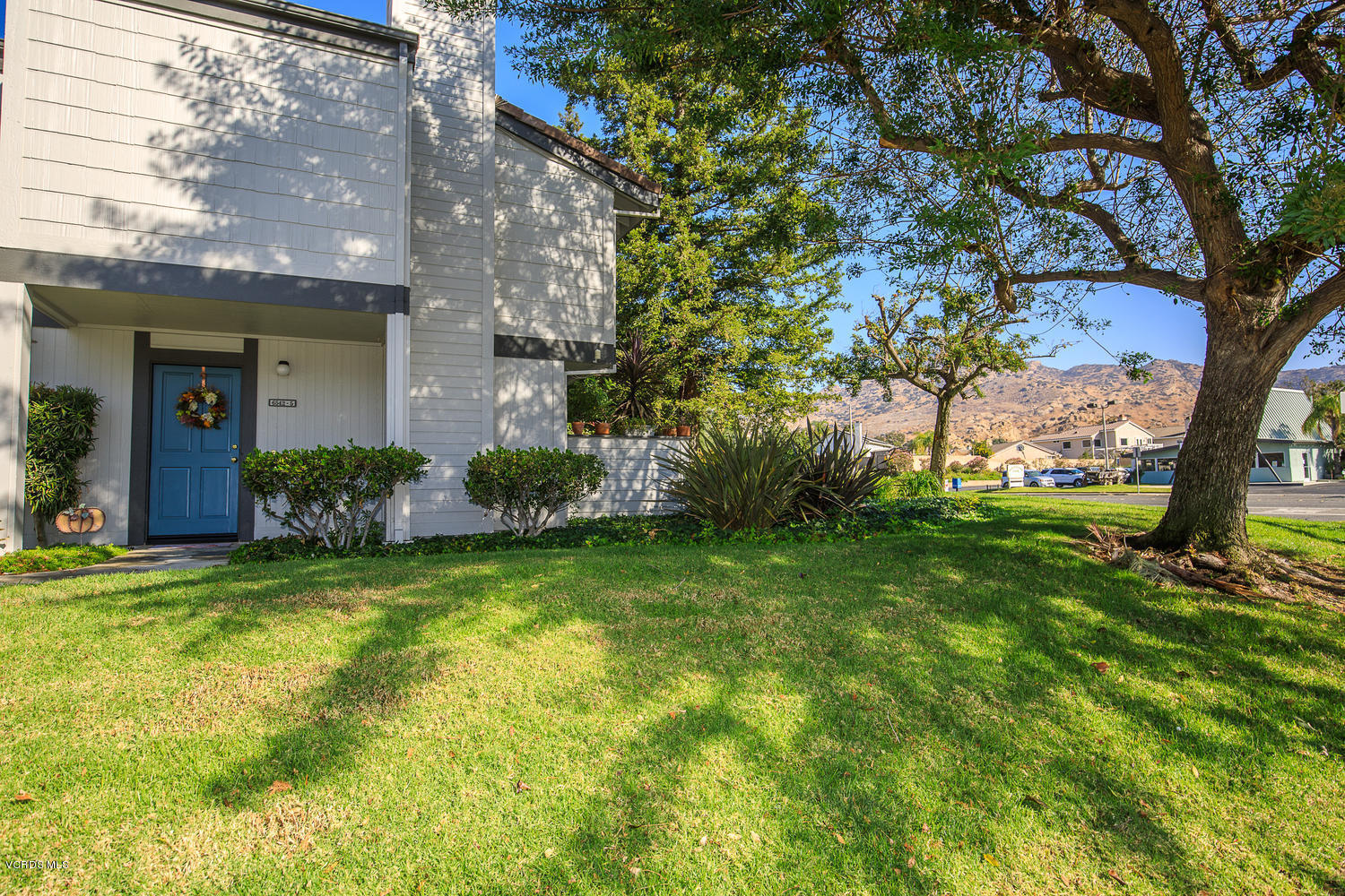 6542 Stoney View Lane, Unit 5 Simi Valley, CA 93063 - Photo 3 of 32 a view of a house with a large tree and a yard