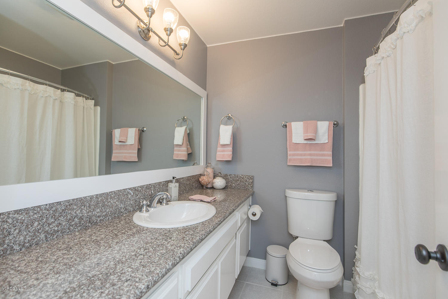 6542 Stoney View Lane, Unit 5 Simi Valley, CA 93063 - Photo 23 of 32 a bathroom with a granite countertop sink a toilet and a mirror