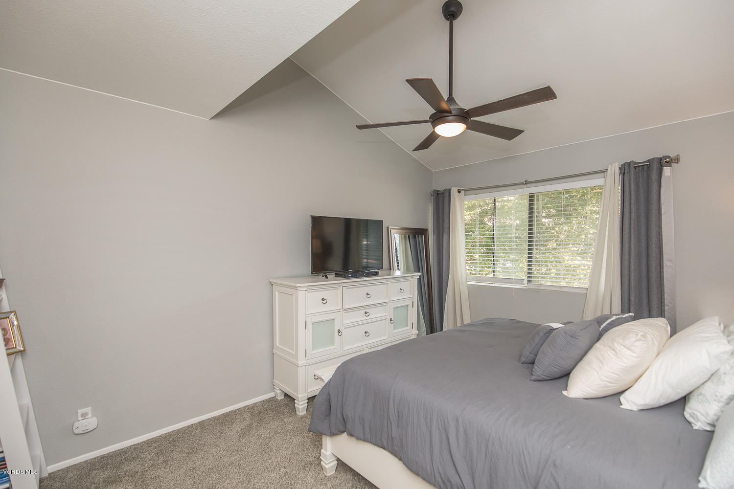 6542 Stoney View Lane, Unit 5 Simi Valley, CA 93063 - Photo 25 of 32 a bedroom with a bed and a flat screen tv
