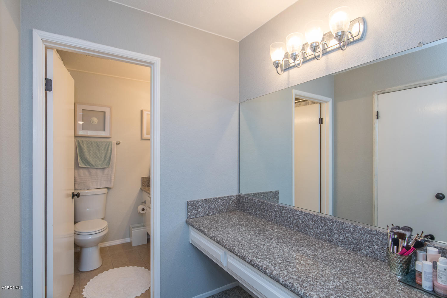 6542 Stoney View Lane, Unit 5 Simi Valley, CA 93063 - Photo 26 of 32 a bathroom with a granite countertop sink a toilet and shower