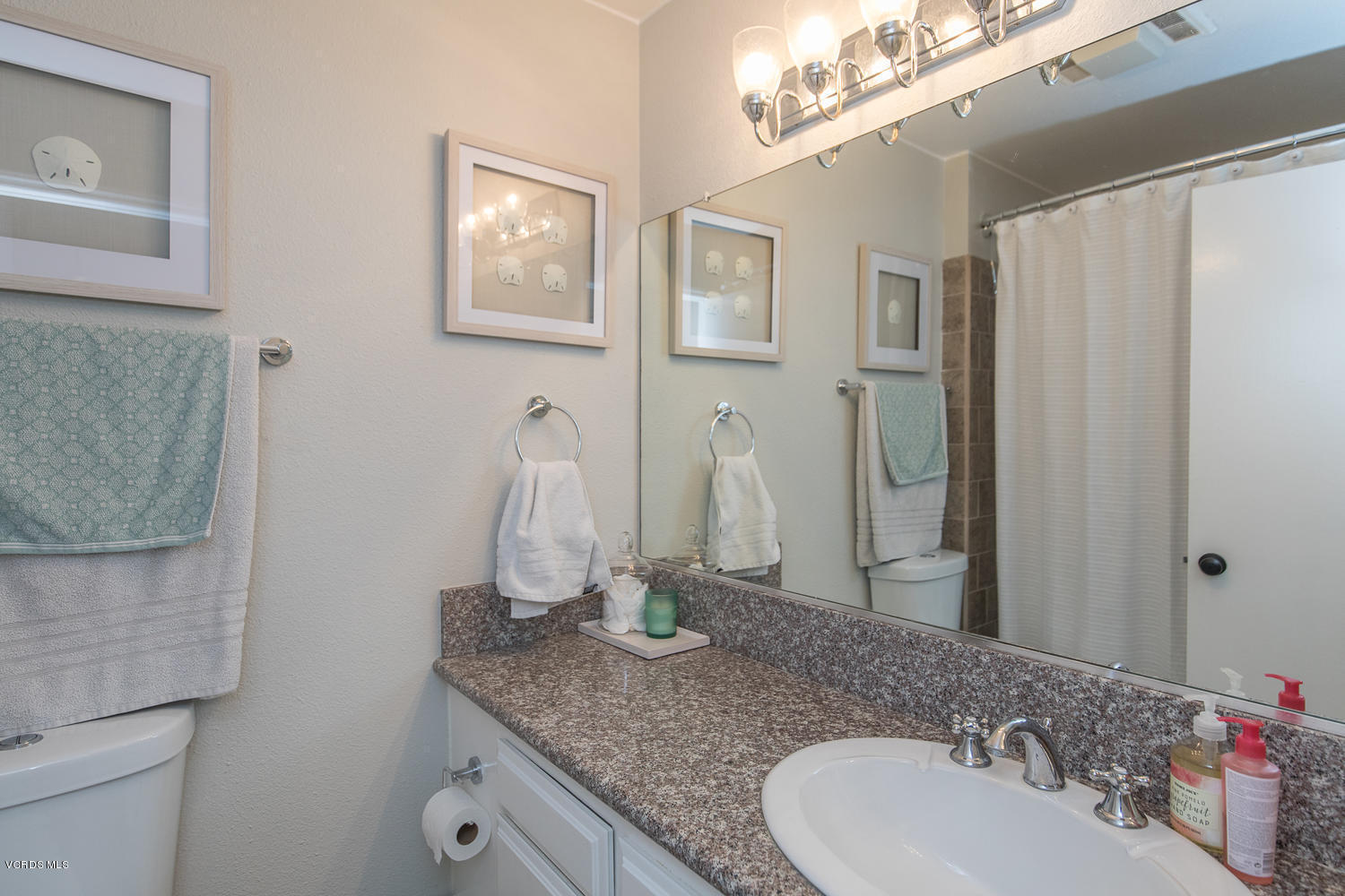 6542 Stoney View Lane, Unit 5 Simi Valley, CA 93063 - Photo 27 of 32 a bathroom with a granite countertop sink and a mirror