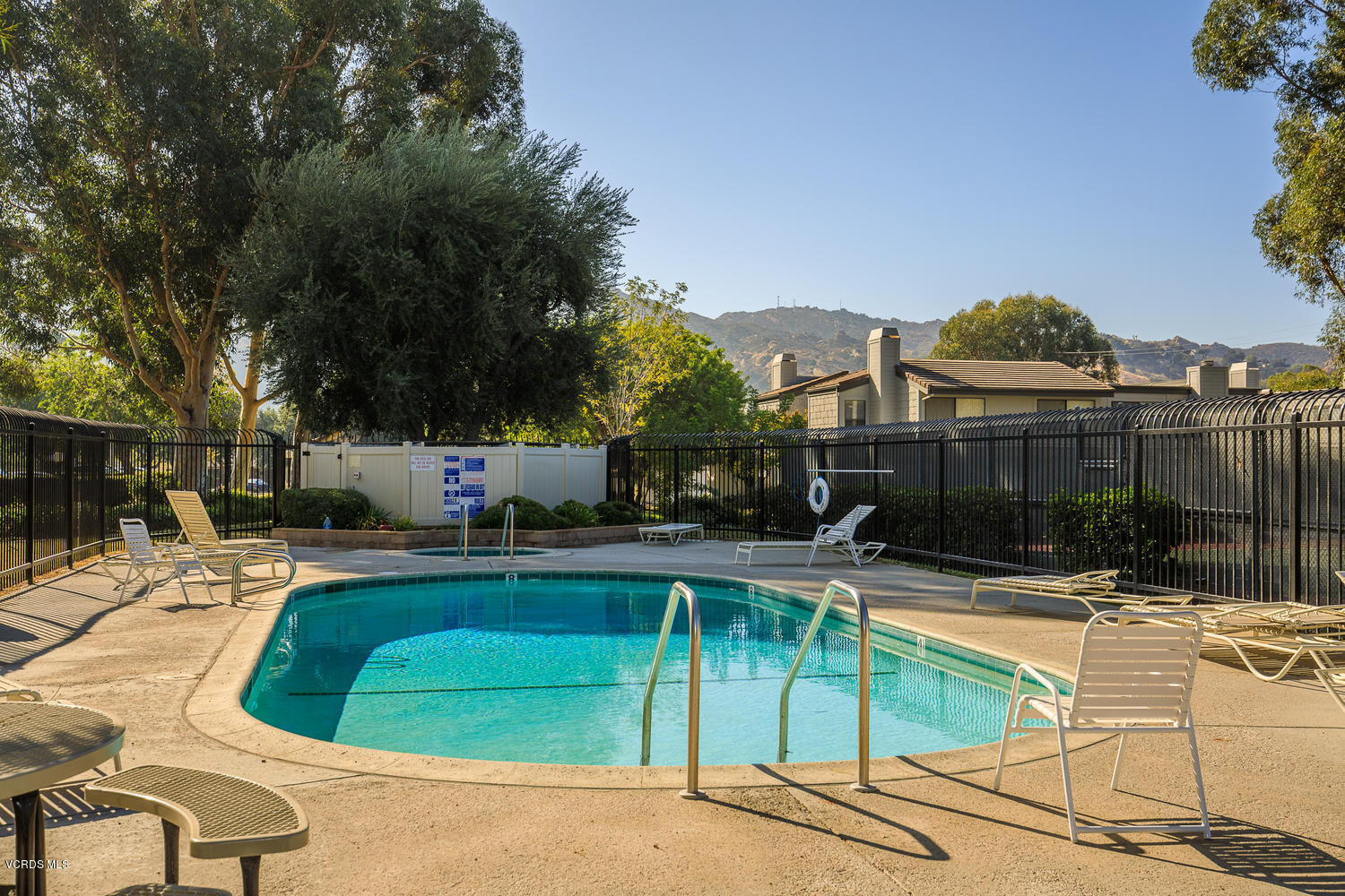 6542 Stoney View Lane, Unit 5 Simi Valley, CA 93063 - Photo 32 of 32 a view of a swimming pool with a lounge chairs