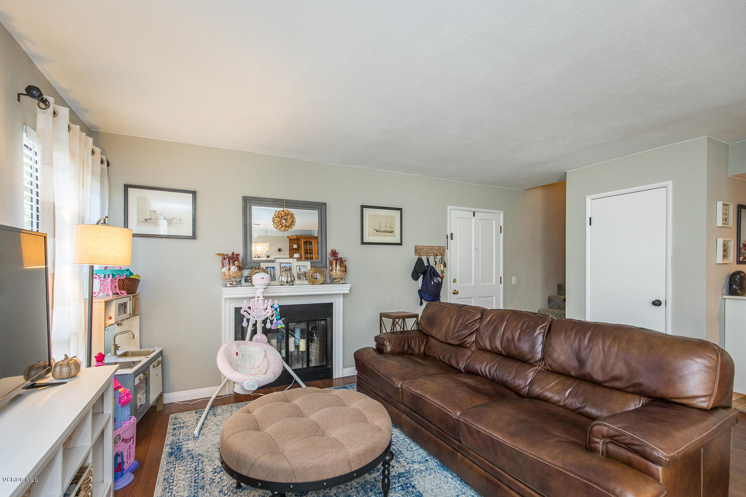 6542 Stoney View Lane, Unit 5 Simi Valley, CA 93063 - Photo 10 of 32 a living room with furniture a couch and a flat screen tv