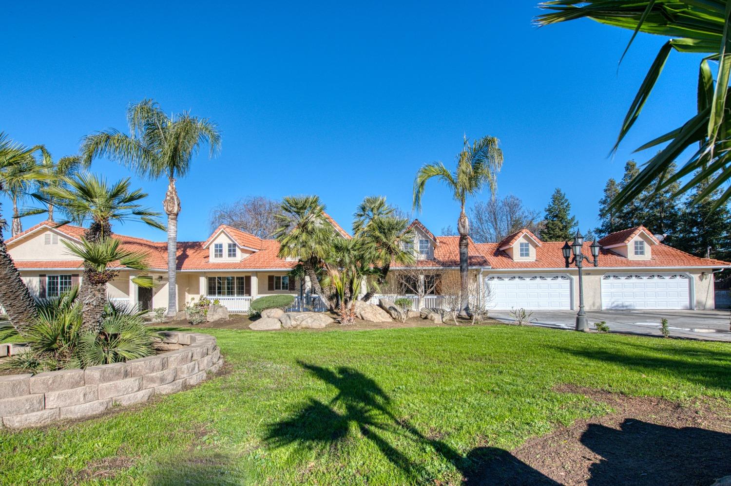 24607 Gardena Drive Madera, CA 93638 - Photo 2 of 74 a view of a white house with a yard table and chairs