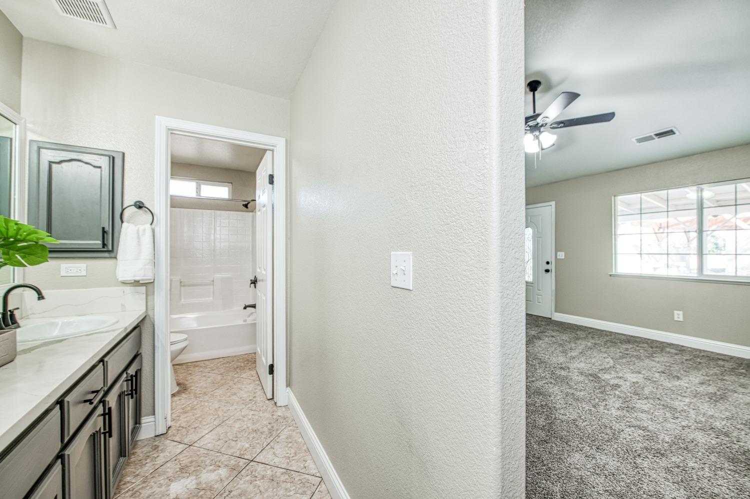 24607 Gardena Drive Madera, CA 93638 - Photo 33 of 74 a bathroom with a sink a toilet and shower