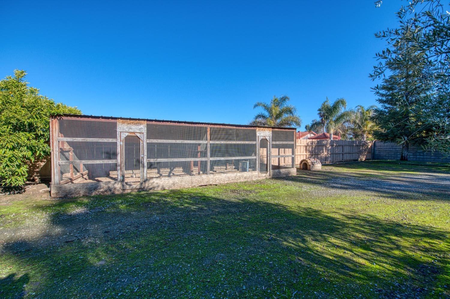 24607 Gardena Drive Madera, CA 93638 - Photo 53 of 74 a front view of a house with swimming pool having outdoor seating