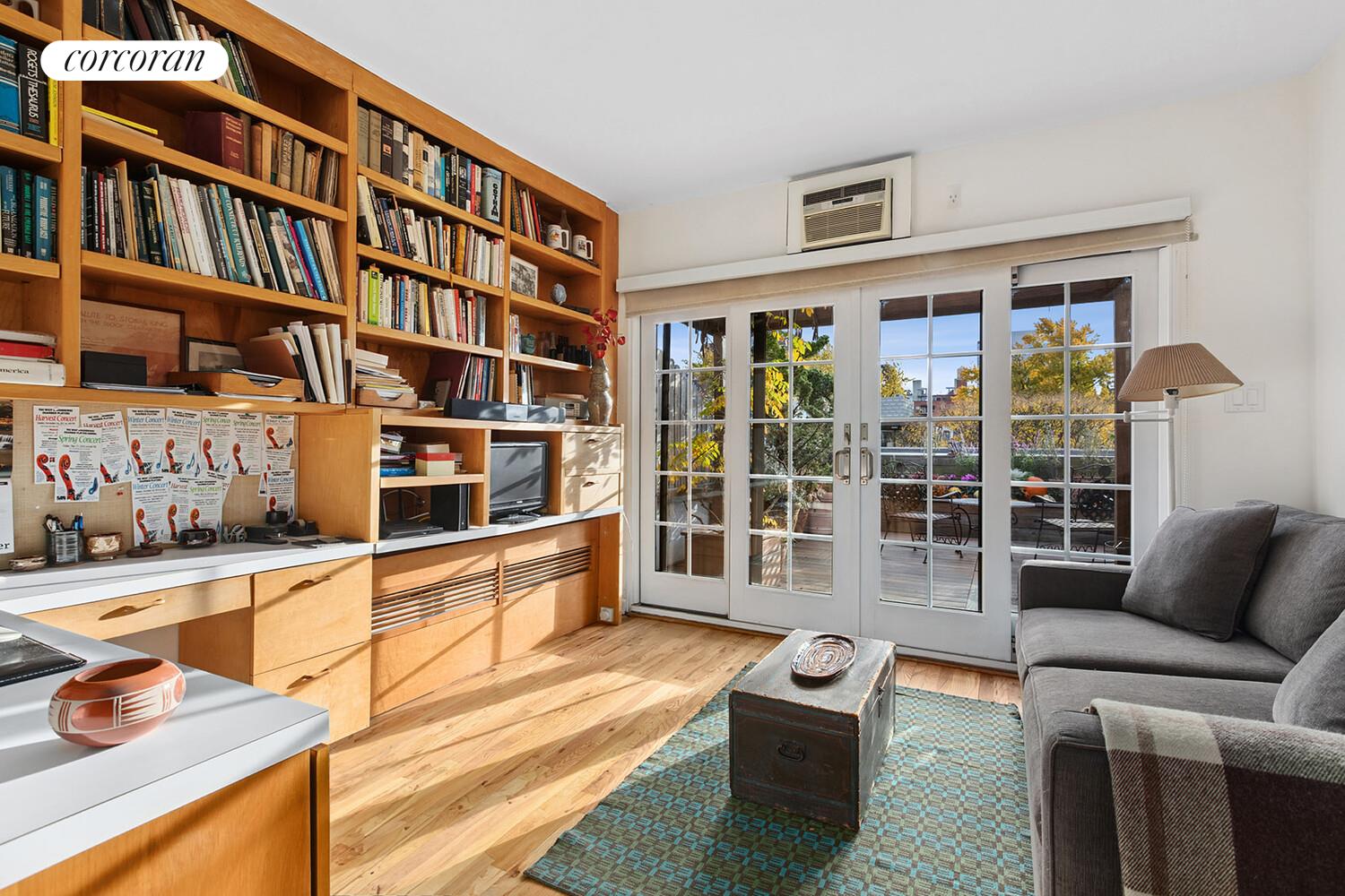 471 West 22nd Street, Unit F Manhattan, NY 10011 - Photo 9 of 13 a room with furniture and a book shelf
