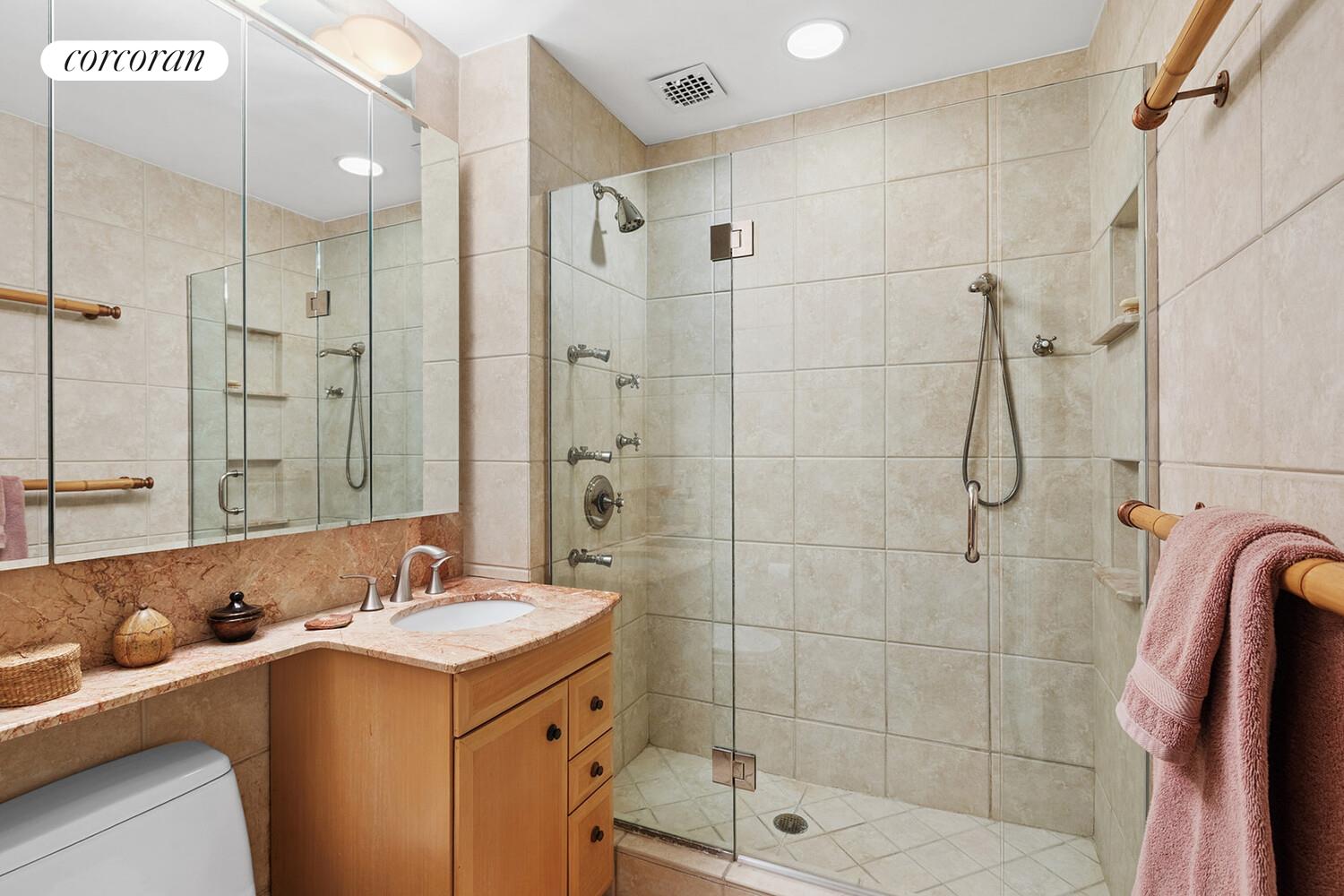 471 West 22nd Street, Unit F Manhattan, NY 10011 - Photo 7 of 13 a bathroom with a shower sink and mirror