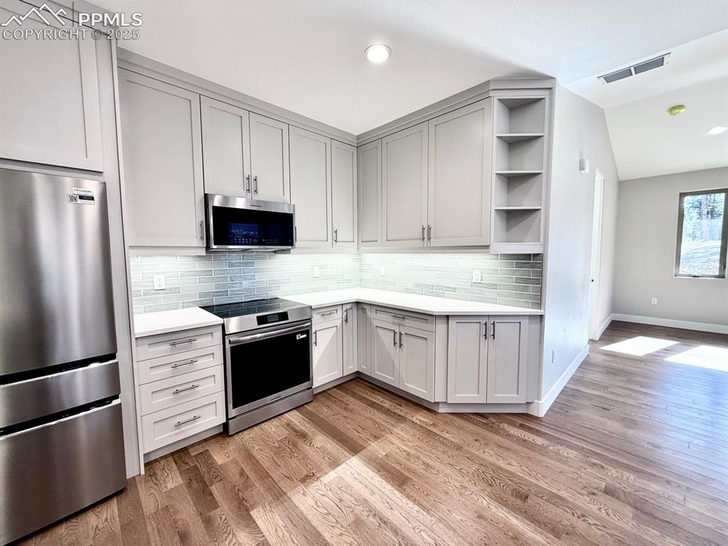 3155 Promise Point Colorado Springs, CO 80921 - Photo 11 of 26 a kitchen with stainless steel appliances granite countertop a refrigerator and a stove top oven