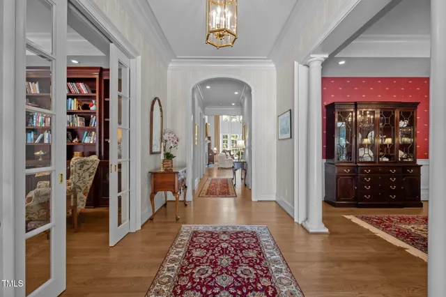 a living room with fireplace furniture and a chandelier
