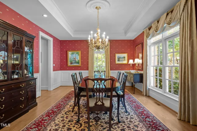 a living room with fireplace furniture and a chandelier