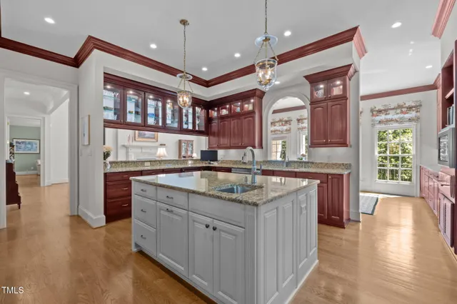 a kitchen with granite countertop a sink and a stove