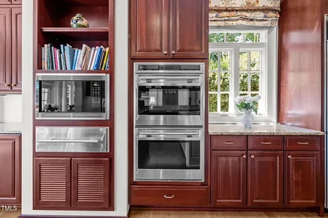 a bathroom with a granite countertop toilet sink and mirror