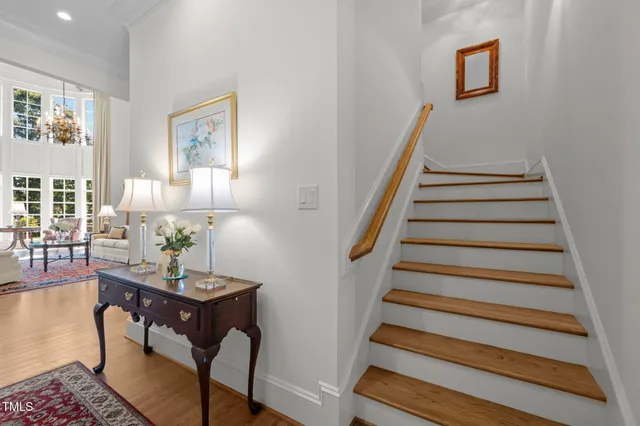 a spacious bedroom with a bed and a chandelier