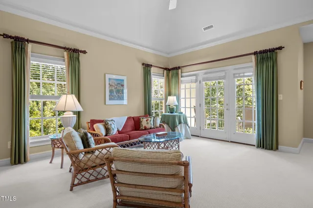 a bedroom with two beds and a chandelier