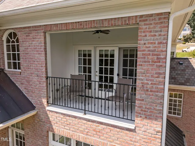 a bathroom with a granite countertop toilet a sink and a mirror