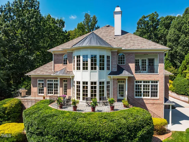 a front view of a house with a yard table and chairs
