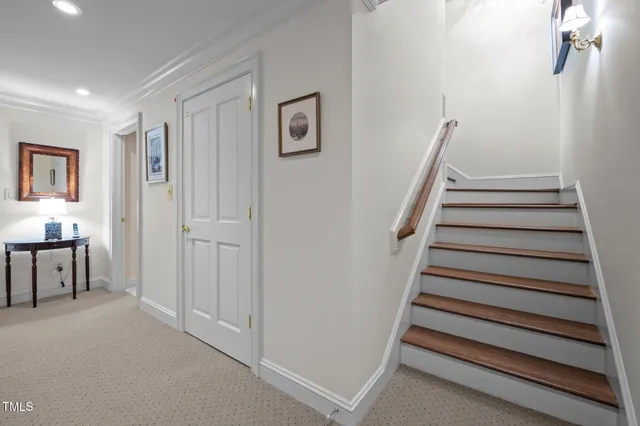 a view of a yard with plants and wooden fence