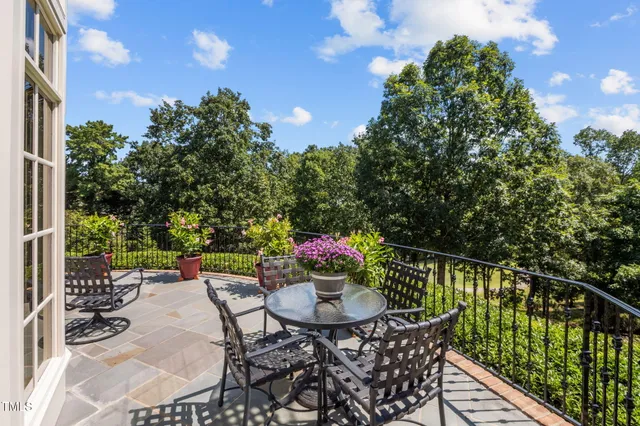 a backyard of a house with table and chairs