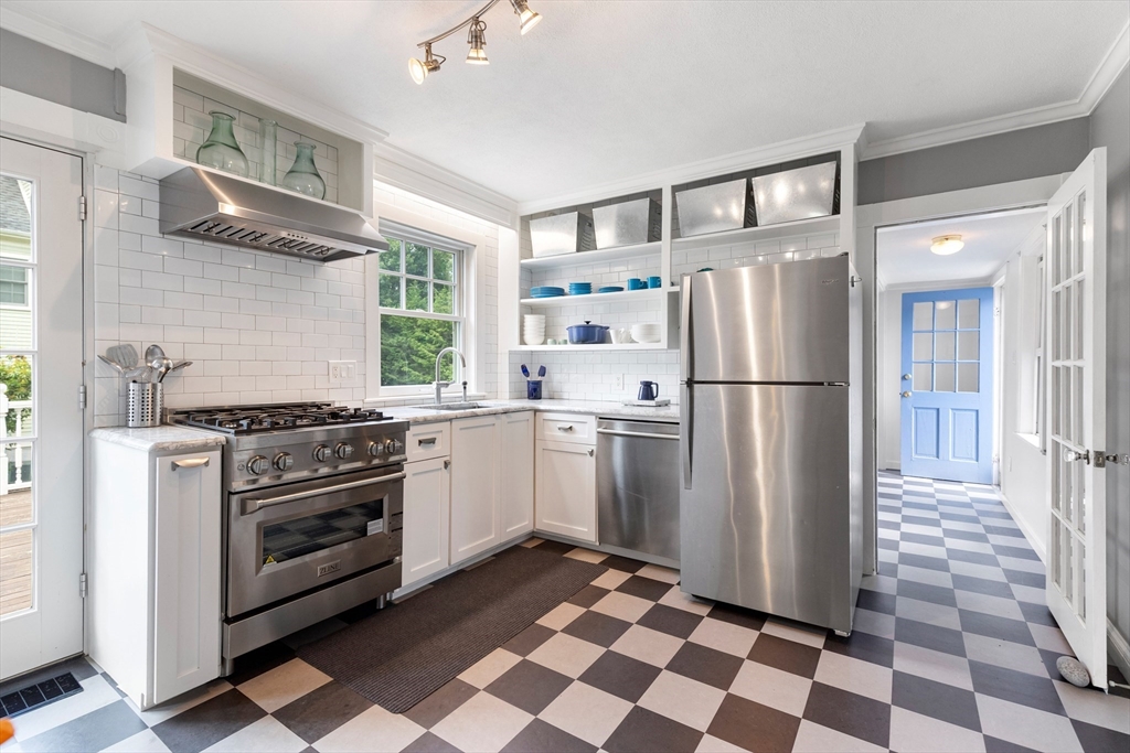 45 Reed Street Lexington, MA 02421 - Photo 14 of 35 a kitchen with a stove a refrigerator and a sink