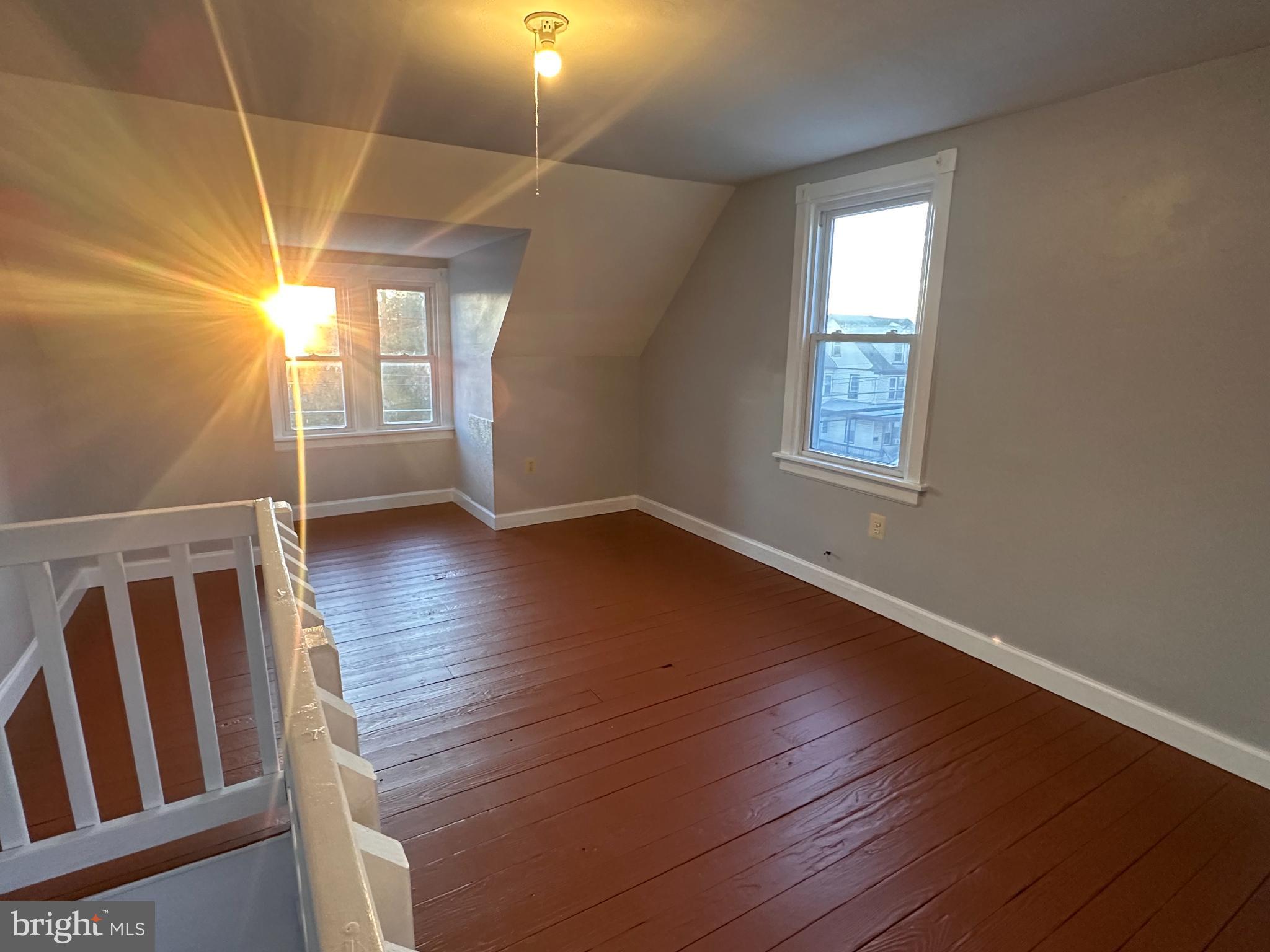 317 South 3rd Street Millville, NJ 08332 - Photo 7 of 8 a view of an empty room with wooden floor and window