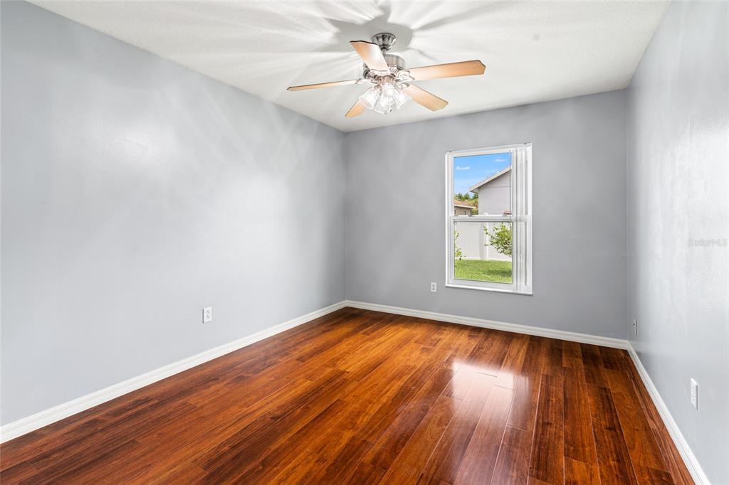 28390 Openfield Loop Wesley Chapel, FL 33543 - Photo 21 of 44 wooden floor in an empty room with a window