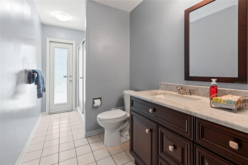 28390 Openfield Loop Wesley Chapel, FL 33543 - Photo 23 of 44 a bathroom with a granite countertop sink toilet and shower