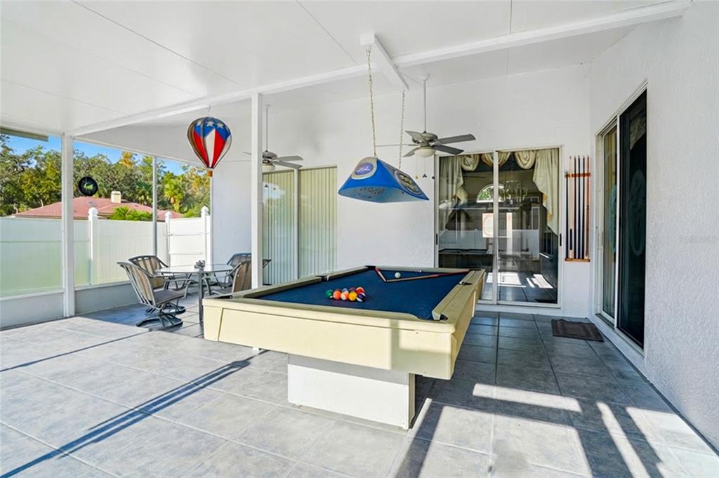 28390 Openfield Loop Wesley Chapel, FL 33543 - Photo 26 of 44 a living room with furniture and a floor to ceiling window