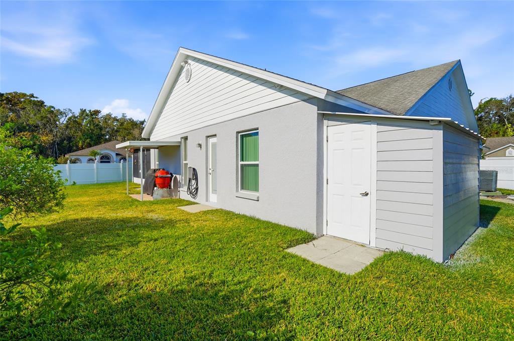 28390 Openfield Loop Wesley Chapel, FL 33543 - Photo 28 of 44 a view of a house with a backyard
