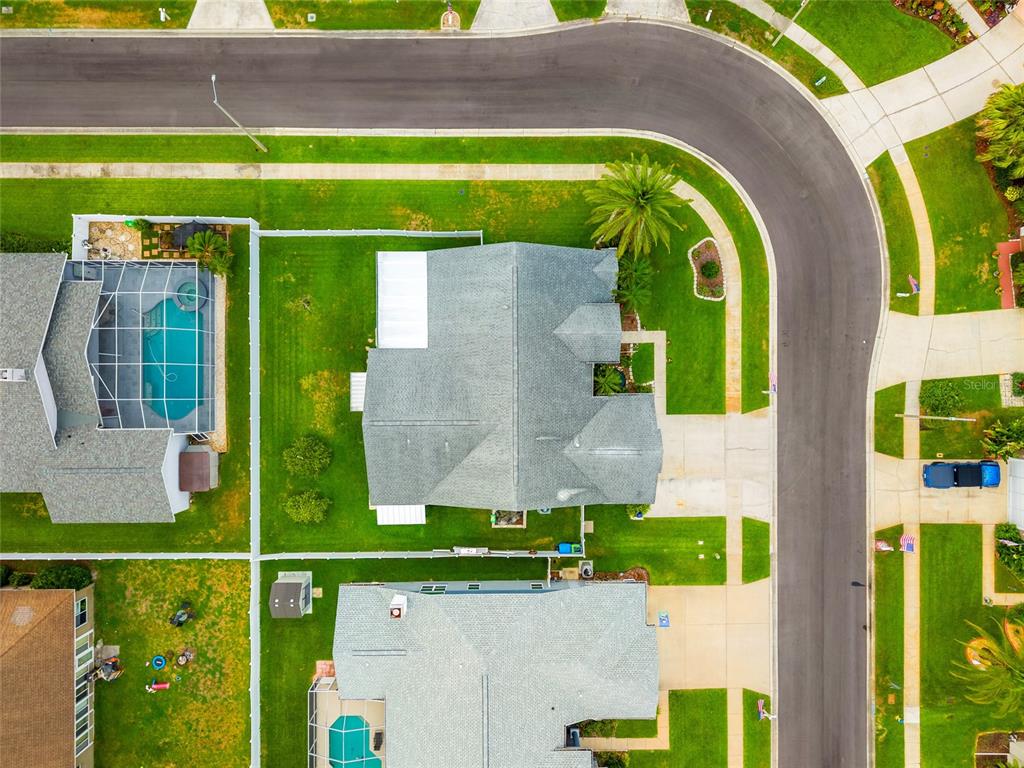 28390 Openfield Loop Wesley Chapel, FL 33543 - Photo 30 of 44 an aerial view of a house with a garden and a garage