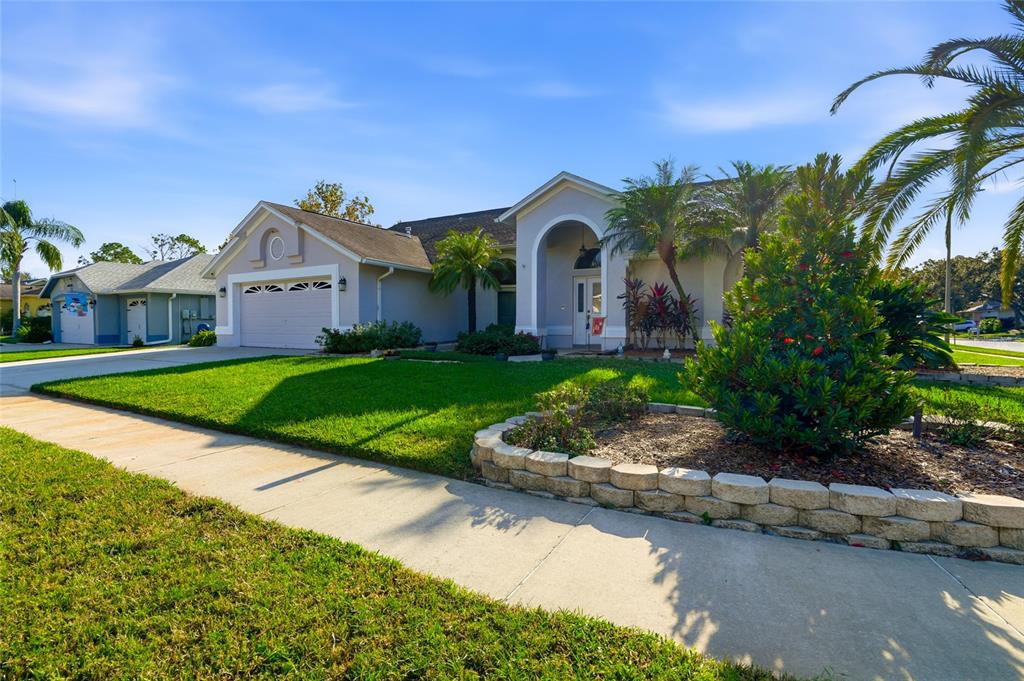 28390 Openfield Loop Wesley Chapel, FL 33543 - Photo 3 of 44 a front view of a house with a yard and potted plants