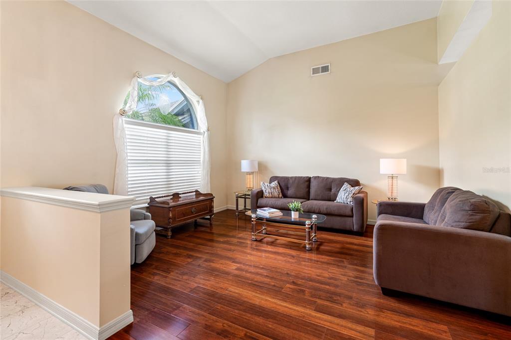 28390 Openfield Loop Wesley Chapel, FL 33543 - Photo 5 of 44 a living room with furniture and a wooden floor