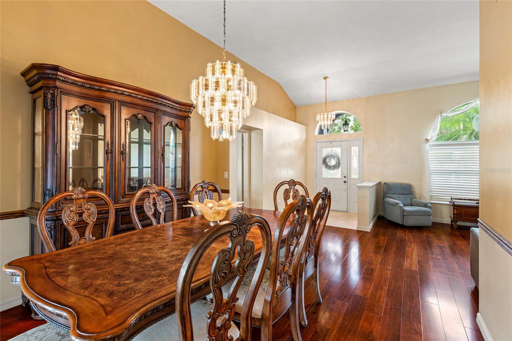 28390 Openfield Loop Wesley Chapel, FL 33543 - Photo 7 of 44 a view of a dining room with furniture and wooden floor