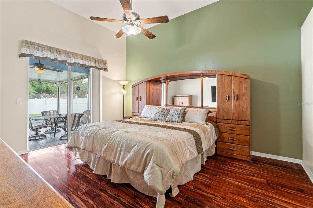 28390 Openfield Loop Wesley Chapel, FL 33543 - Photo 8 of 44 a bed room with a bed and a chandelier