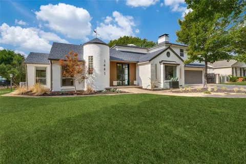 a front view of a house with a garden and plants