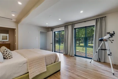 a bedroom with a bed and a wooden floor
