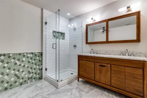 a bathroom with a granite countertop sink mirror and double