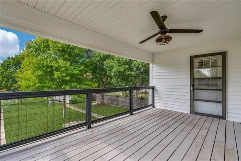 a view of a balcony with wooden floor