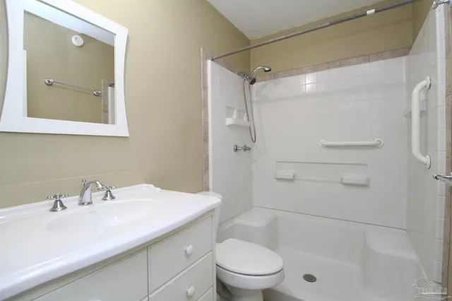 a bathroom with a sink toilet and shower