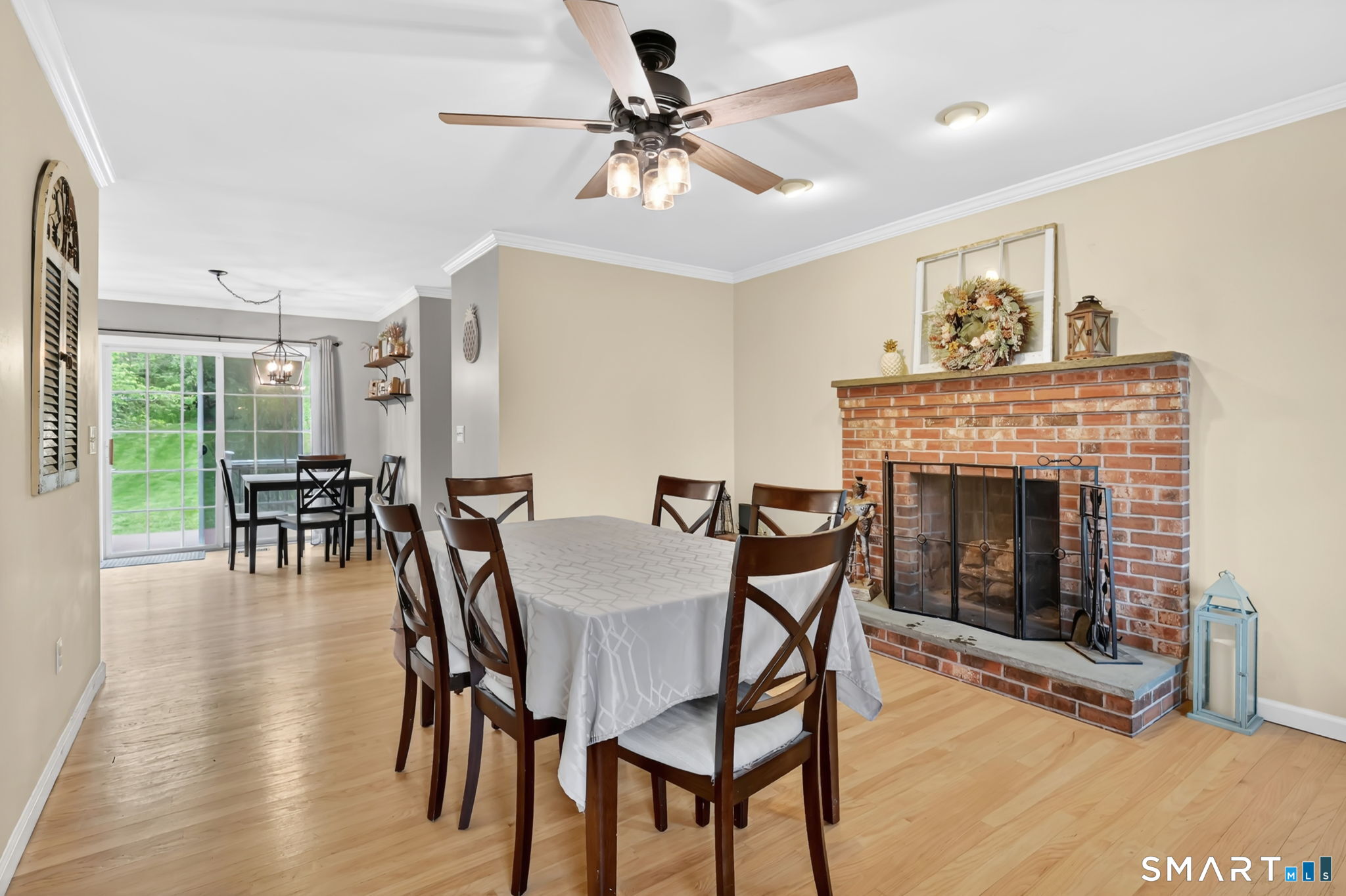 5 Tuckers Run Ledyard, CT 06339 - Photo 15 of 39 a dining room with furniture a fireplace and wooden floor