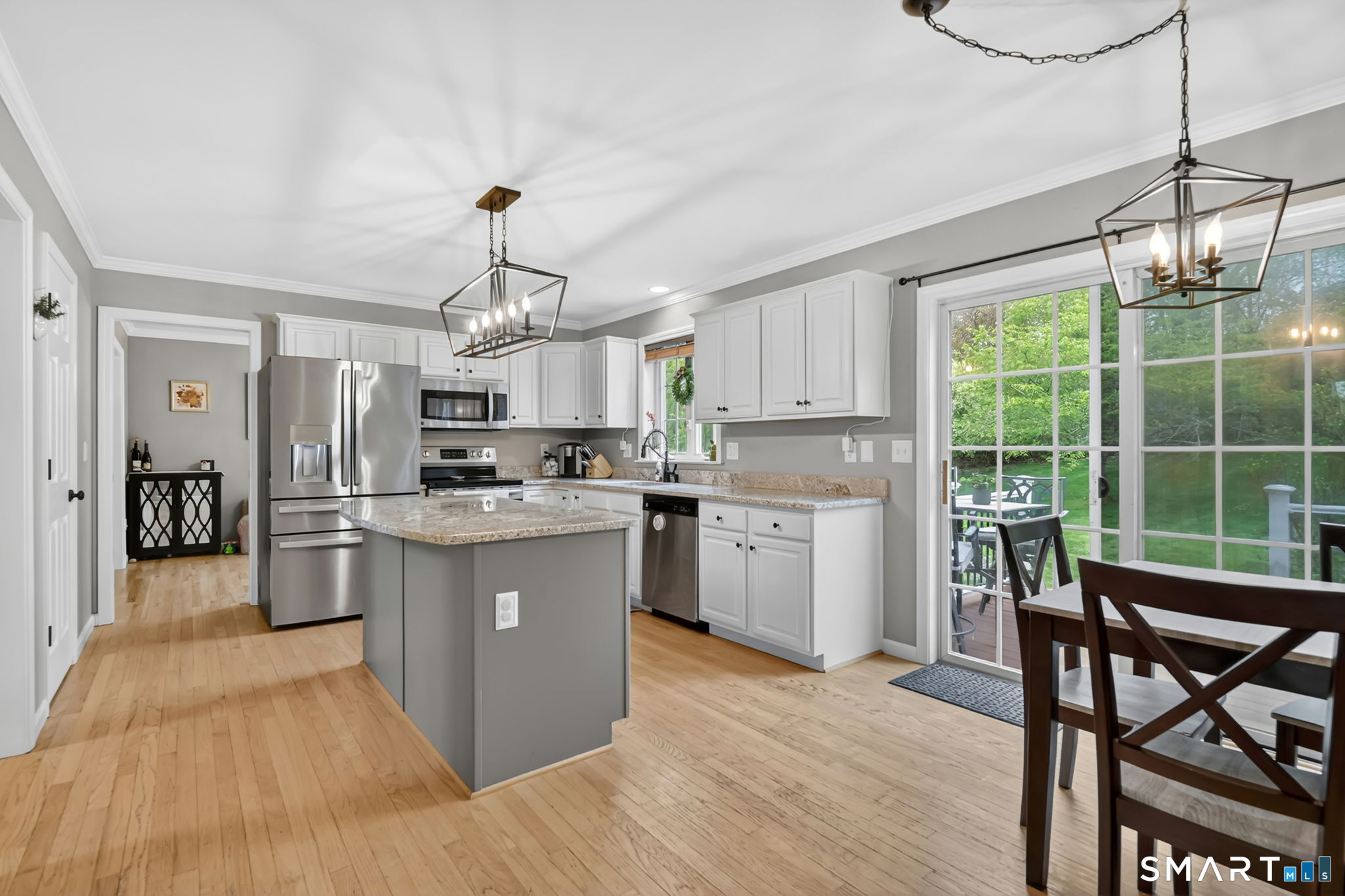 5 Tuckers Run Ledyard, CT 06339 - Photo 17 of 39 a kitchen with a table chairs refrigerator and cabinets