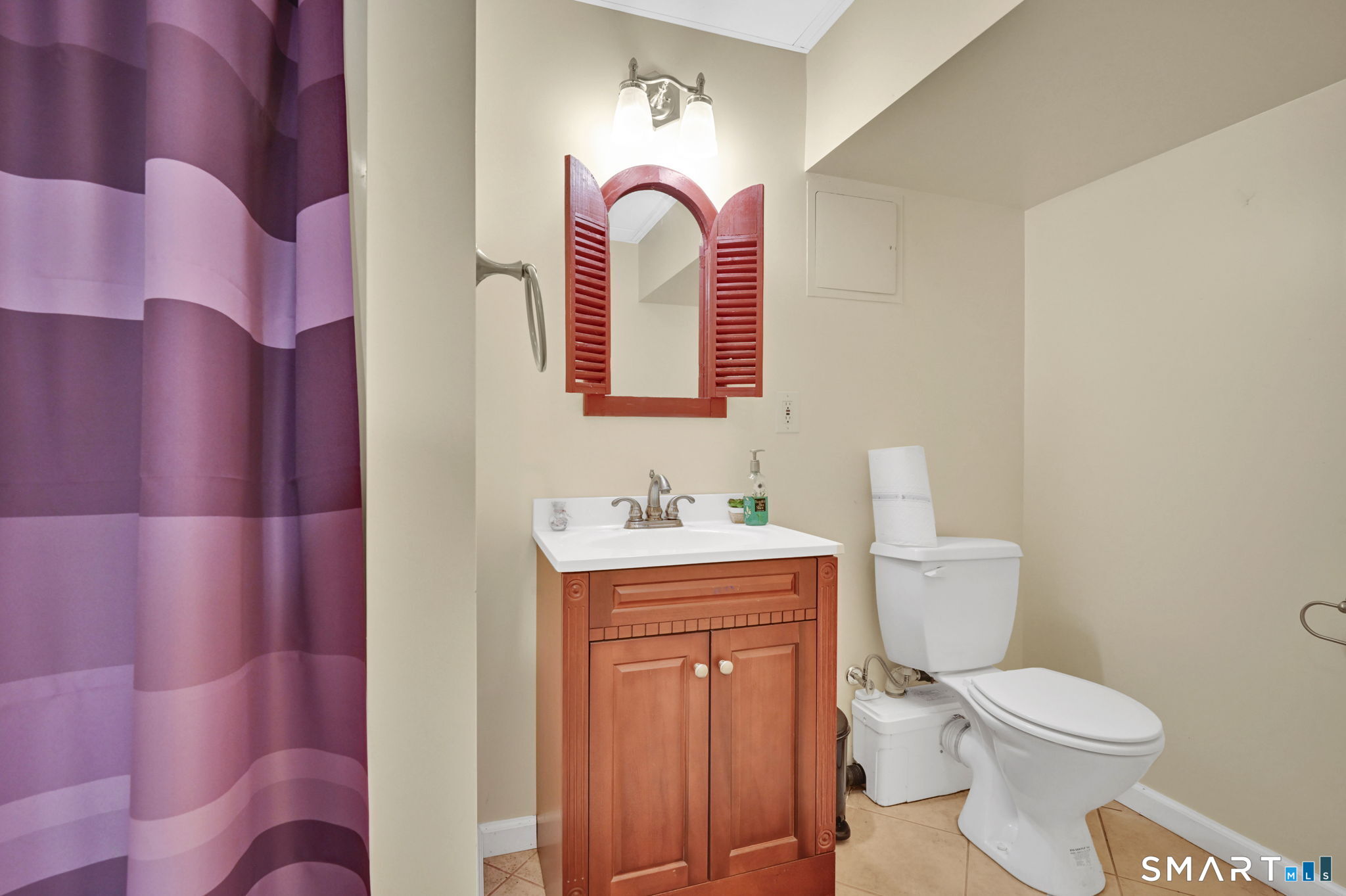 5 Tuckers Run Ledyard, CT 06339 - Photo 33 of 39 a bathroom with a toilet sink vanity and mirror