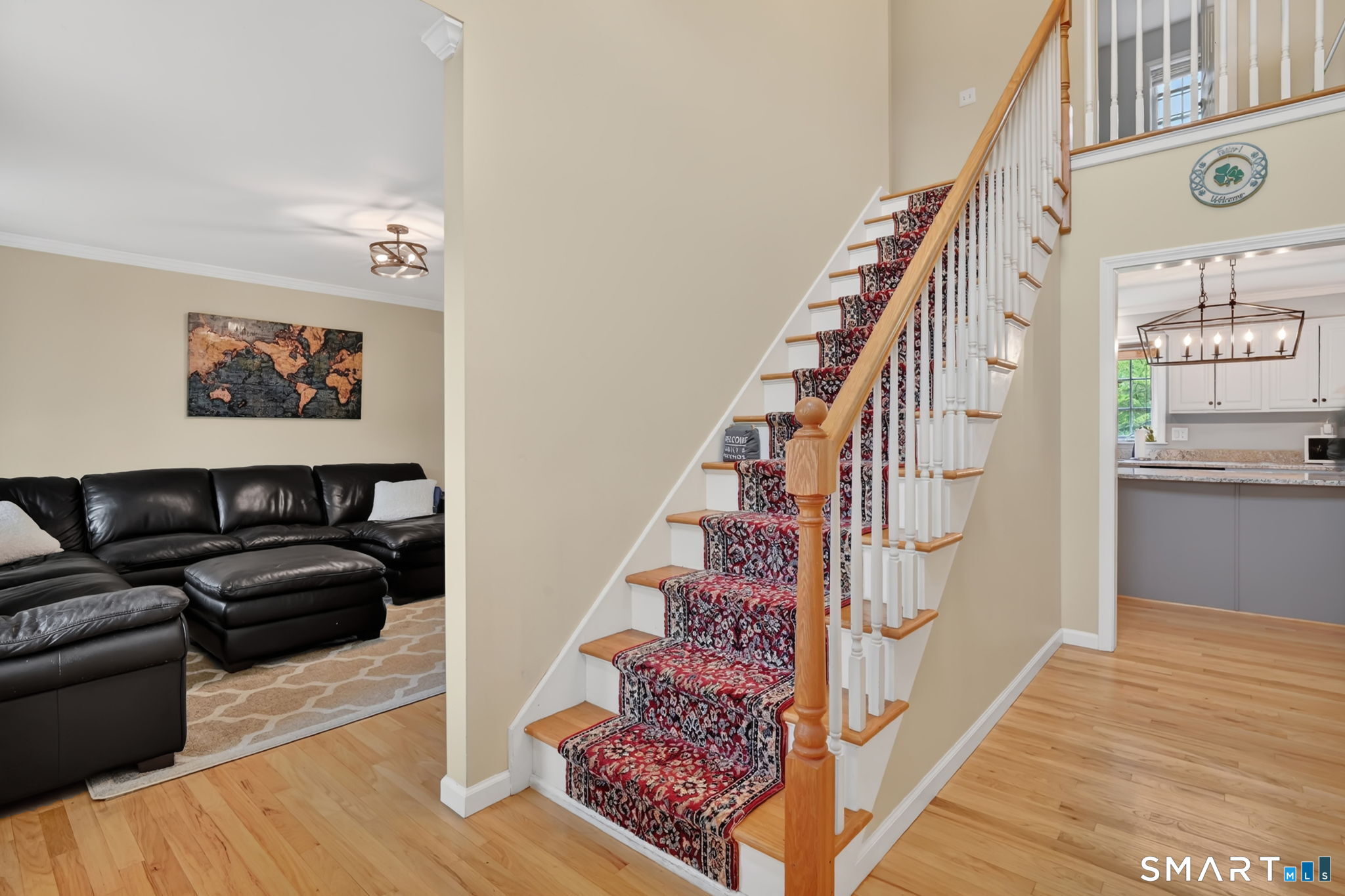 5 Tuckers Run Ledyard, CT 06339 - Photo 9 of 39 a view of a hallway with wooden floor and stairs