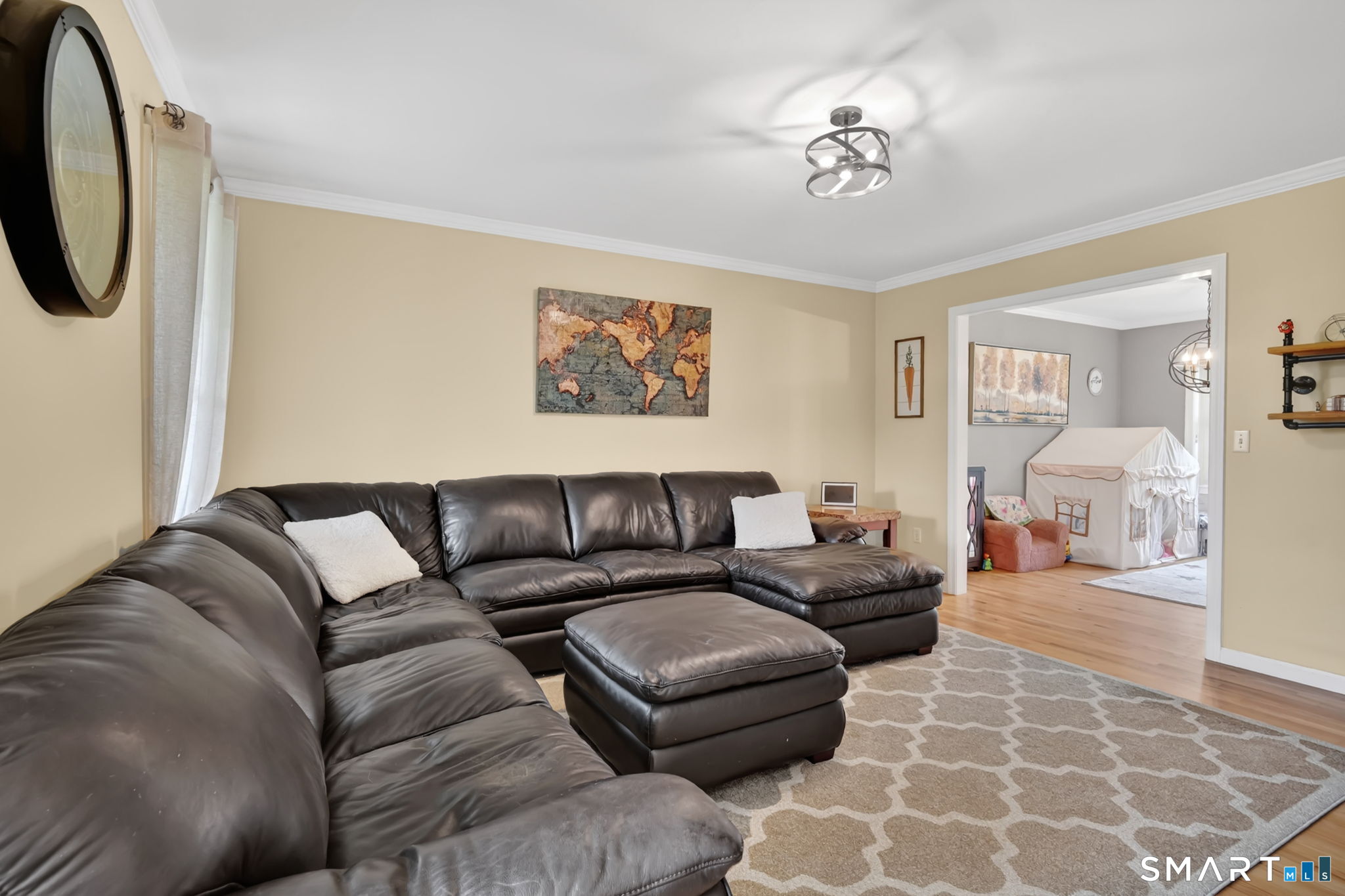5 Tuckers Run Ledyard, CT 06339 - Photo 10 of 39 a living room with furniture and a chandelier