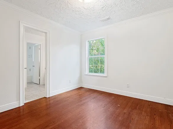 an empty room with wooden floor