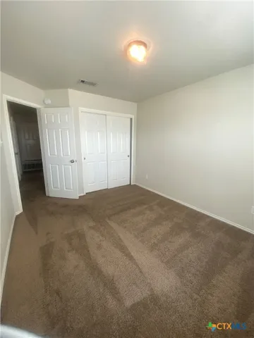 a spacious bathroom with a granite countertop sink a mirror and a bathtub