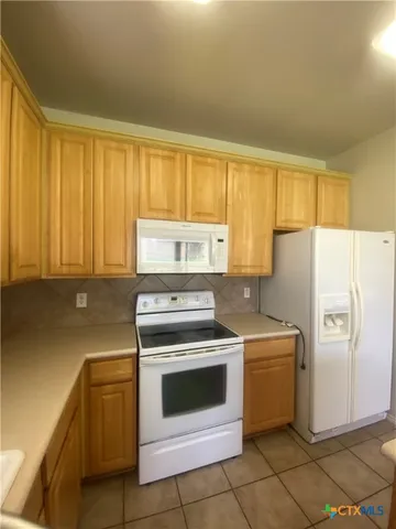a kitchen with a stove sink and refrigerator