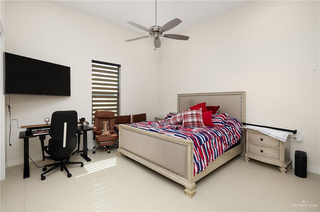 4401 South L Street McAllen, TX 78503 - Photo 11 of 20 a bedroom with a bed and a flat screen tv