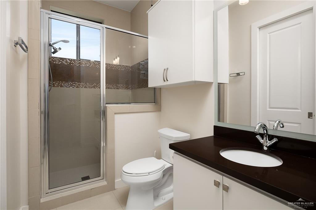 4401 South L Street McAllen, TX 78503 - Photo 12 of 20 a bathroom with a sink and a mirror