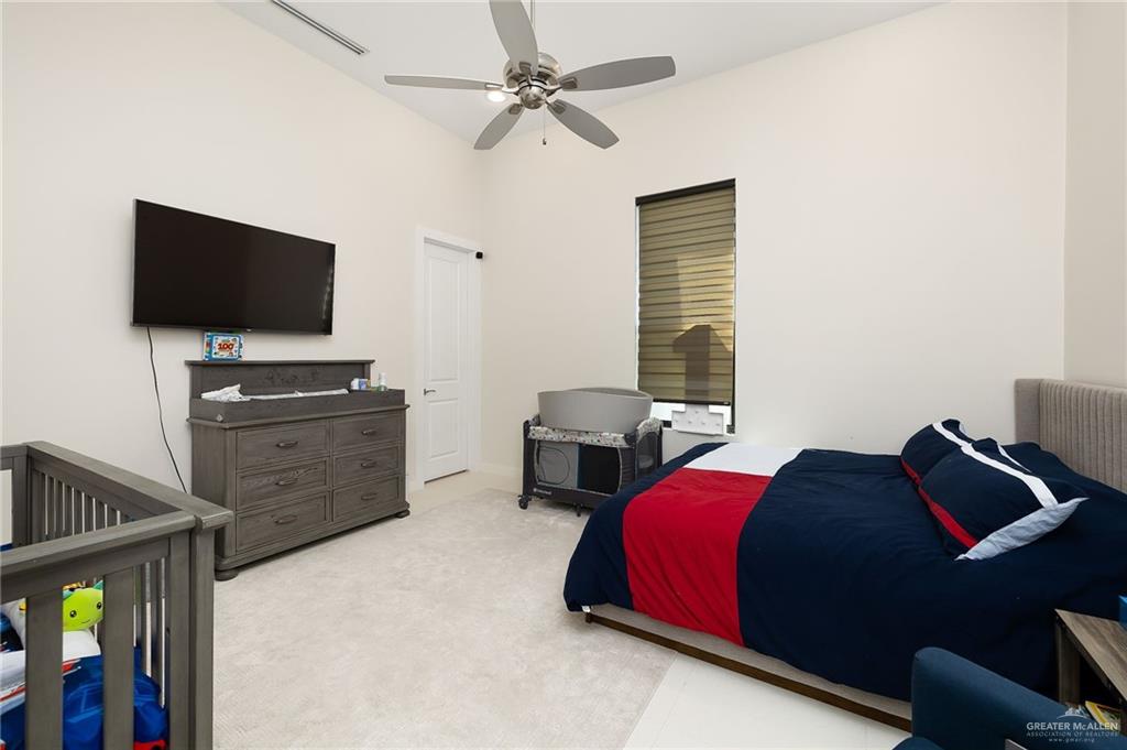 4401 South L Street McAllen, TX 78503 - Photo 13 of 20 a bedroom with a bed and a flat screen tv